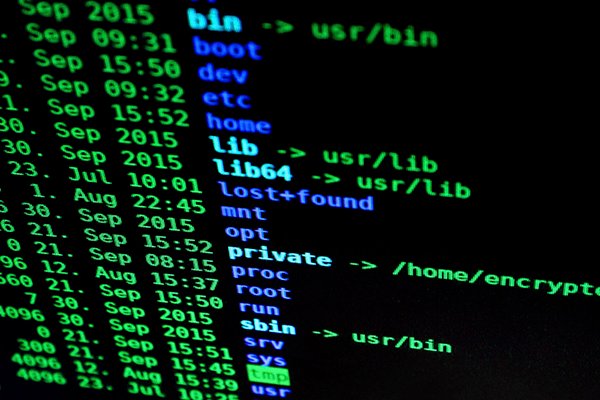 A computer screen with black screen and written codes