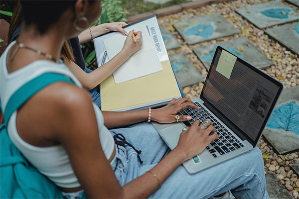 A female student sitting and typing on her laptop
